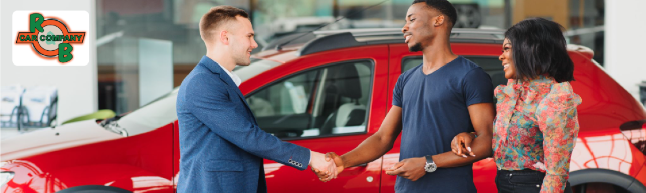  Sales representative assisting a customer with pre-owned SUV financing options at R&B Car Company.