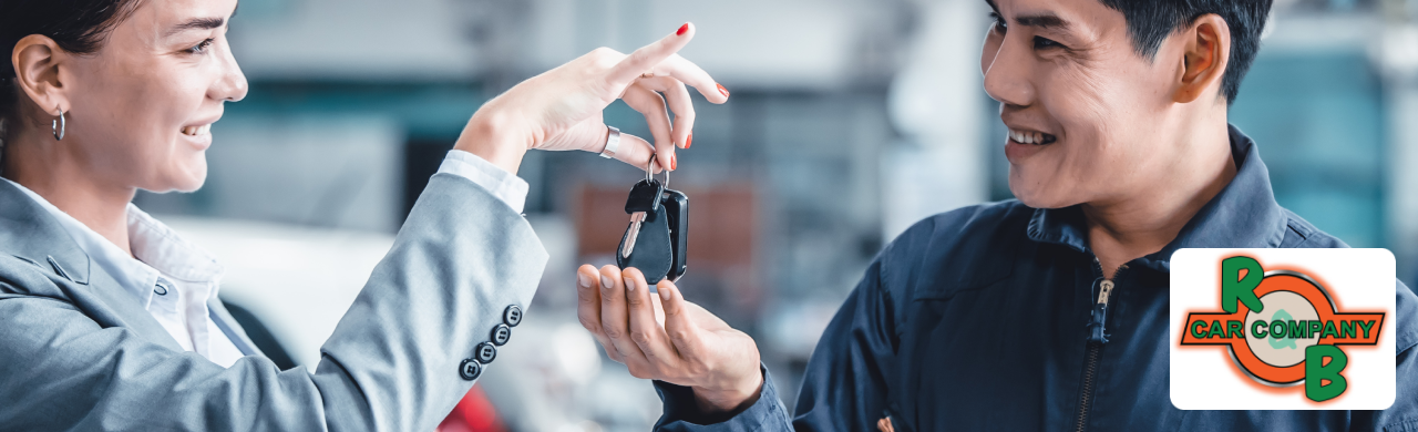 Customer exploring a lineup of used cars at R&B Car Company with dealership branding visible in the background