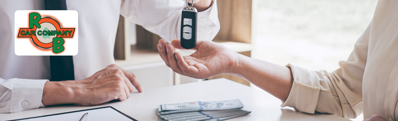 Customer reviewing trade-in value appraisal at R&B Car Company with vehicles displayed in the background