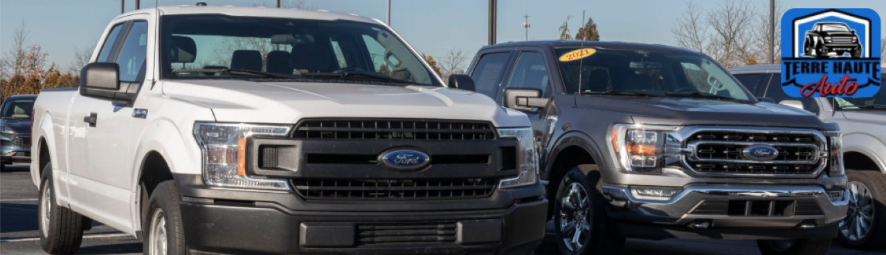 A row of used pickup trucks for sale at the Terre Haute Auto dealership lot in Terre Haute, IN.
