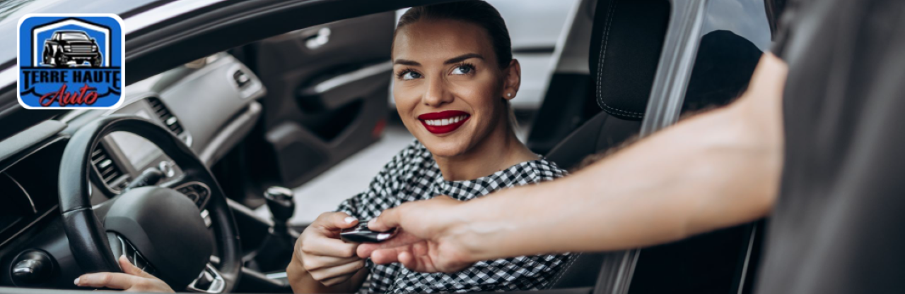 A sales representative is assisting a local family with financing at Terre Haute Auto.