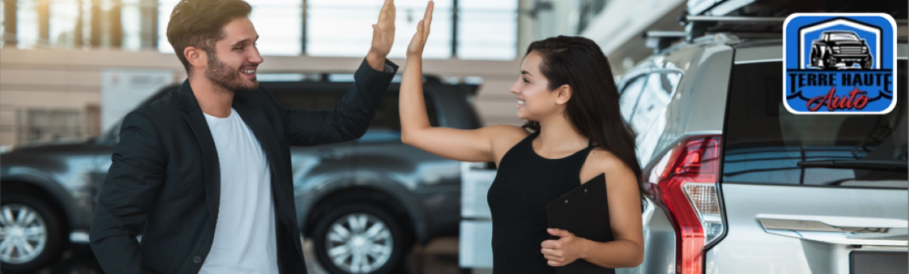 A family exploring a reliable pre-owned SUV inside the Terre Haute Auto dealership.