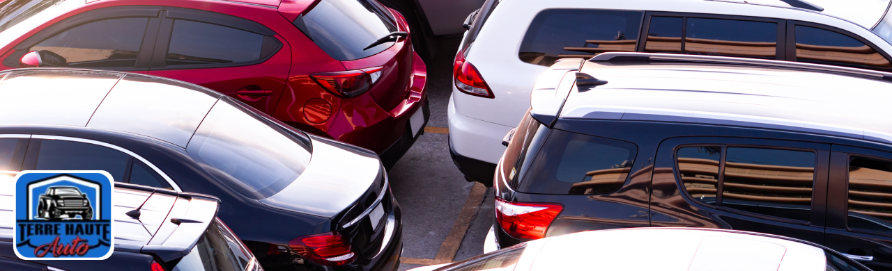 Sales representative handing keys to a happy customer after buying a certified used car at Terre Haute Auto.